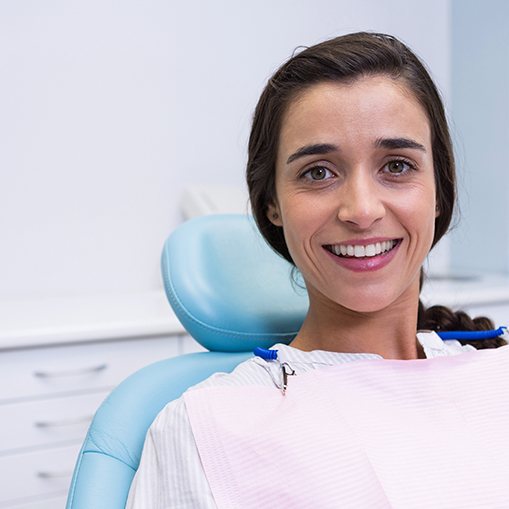 Woman sitting in dental chair smiling