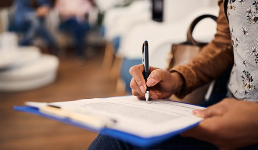 Patient in Oshkosh filling out paperwork for teeth whitening