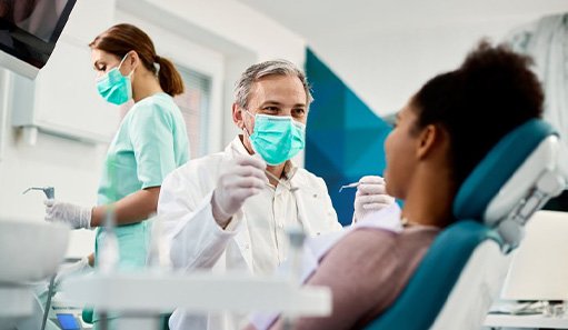 Dentist treats patient